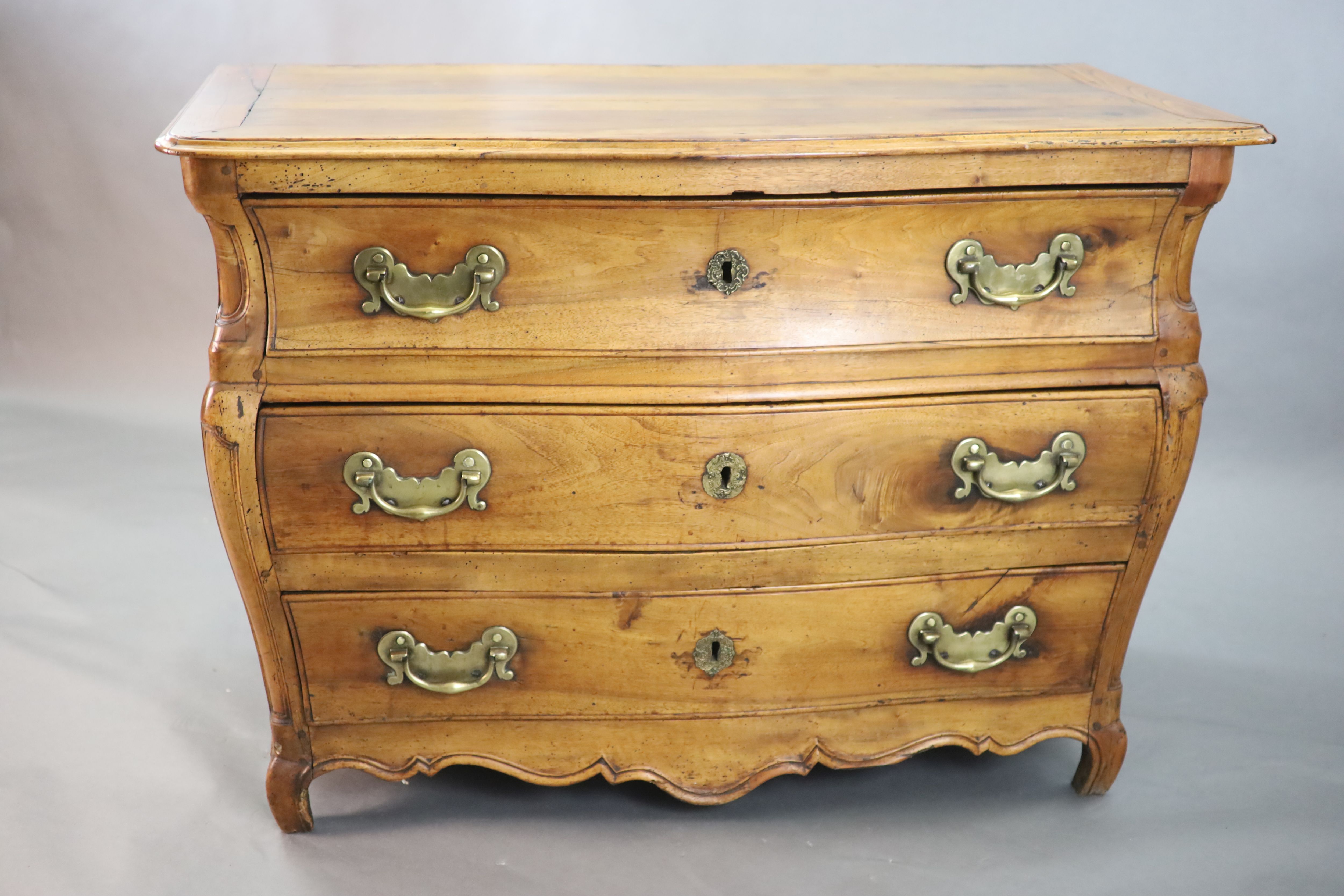 A 19th century Continental walnut serpentine commode, W.3ft 10in. D.2ft 1in. H.2ft 8in.